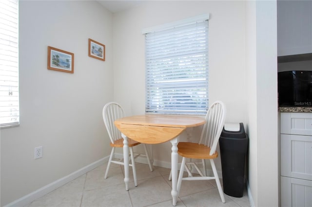 3745 Almeria Ave Unit 7S, Sarasota, FL 34239 - dining area featuring light tile patterned flooring and baseboards