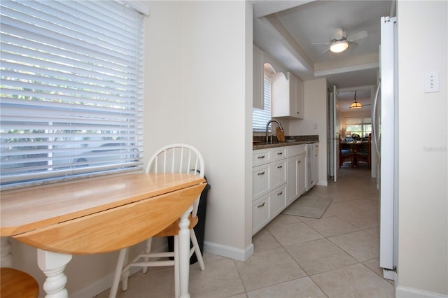 3745 Almeria Ave Unit 7S, Sarasota, FL 34239 - dining area with light tile patterned flooring, baseboards, ceiling fan, and a raised ceiling