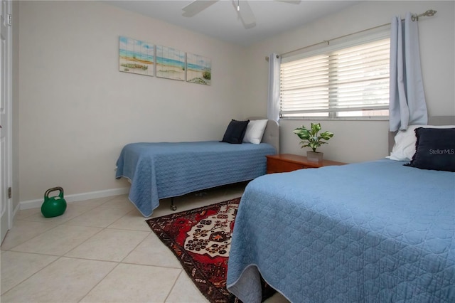 3745 Almeria Ave Unit 7S, Sarasota, FL 34239 - bedroom featuring light tile patterned floors, ceiling fan, and baseboards