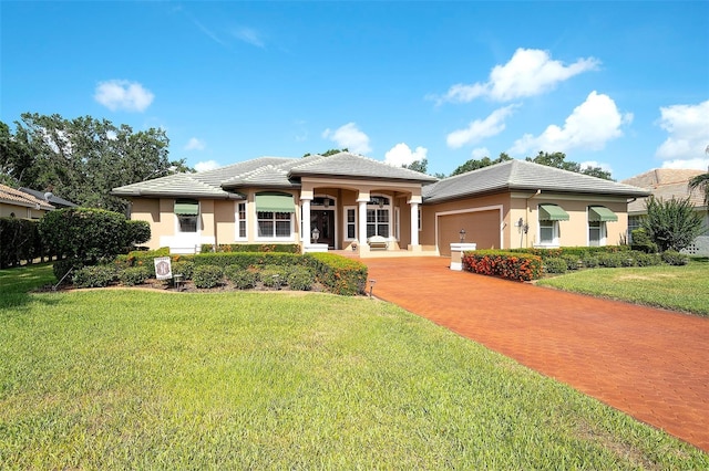 2901 Little Country Rd, Parrish, FL 34219 - view of front of home featuring a garage, a front lawn, a tile roof, driveway, and stucco siding