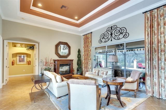 2901 Little Country Rd, Parrish, FL 34219 - living room with light tile patterned floors, crown molding, a glass covered fireplace, a tray ceiling, and recessed lighting