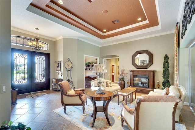 2901 Little Country Rd, Parrish, FL 34219 - tiled entryway featuring a tray ceiling, arched walkways, crown molding, french doors, and a textured ceiling