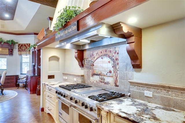 2901 Little Country Rd, Parrish, FL 34219 - kitchen featuring range with two ovens, tasteful backsplash, extractor fan, and light stone countertops