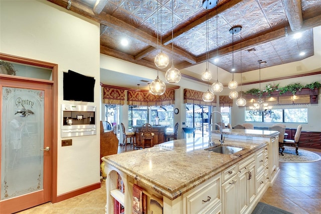 2901 Little Country Rd, Parrish, FL 34219 - kitchen with a sink, light stone countertops, plenty of natural light, and a center island with sink