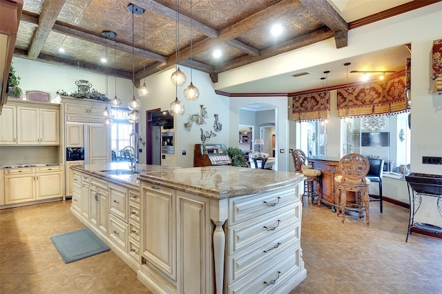 2901 Little Country Rd, Parrish, FL 34219 - kitchen with cream cabinets, a sink, arched walkways, an island with sink, and light stone counters