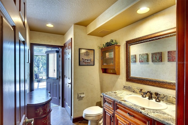2901 Little Country Rd, Parrish, FL 34219 - bathroom featuring vanity, toilet, a textured ceiling, a textured wall, and tile patterned flooring