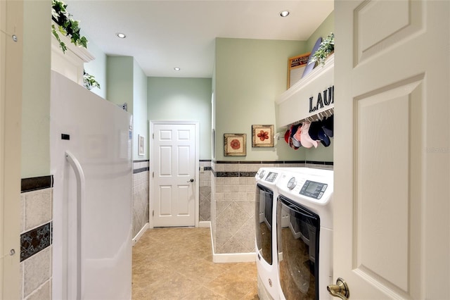 2901 Little Country Rd, Parrish, FL 34219 - washroom featuring tile walls, washing machine and clothes dryer, a wainscoted wall, light tile patterned flooring, and recessed lighting