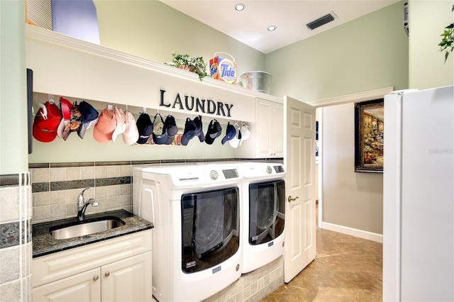 2901 Little Country Rd, Parrish, FL 34219 - washroom with cabinet space, washing machine and clothes dryer, light tile patterned flooring, and recessed lighting