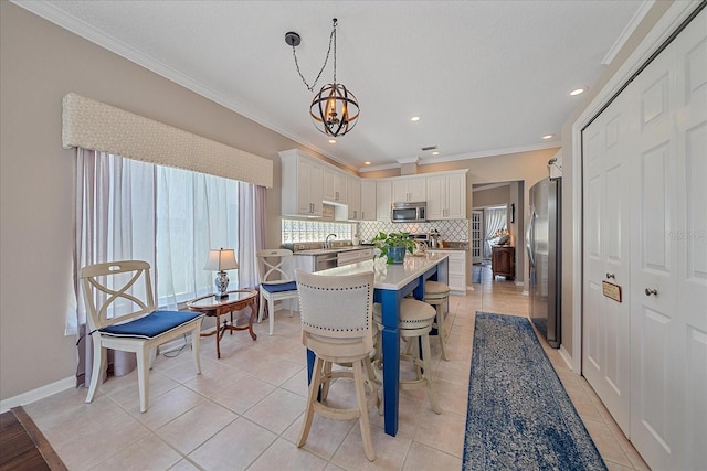 12322 Tall Pines Way, Lakewood Ranch, FL 34202 - dining room with light tile patterned floors, crown molding, a chandelier, recessed lighting, and baseboards