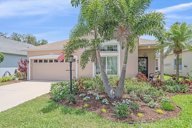 12322 Tall Pines Way, Lakewood Ranch, FL 34202 - view of front of property with stucco siding, an attached garage, and concrete driveway