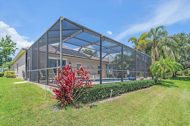 12322 Tall Pines Way, Lakewood Ranch, FL 34202 - back of house featuring a lawn, stucco siding, and an outdoor pool