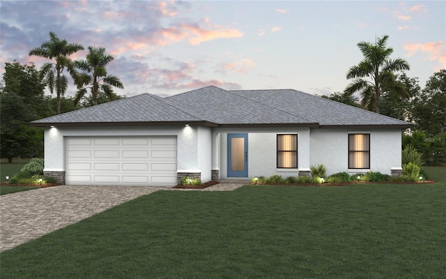 10547 Kidron Ave, Englewood, FL 34224 - view of front of house featuring a garage, a front lawn, decorative driveway, and stucco siding