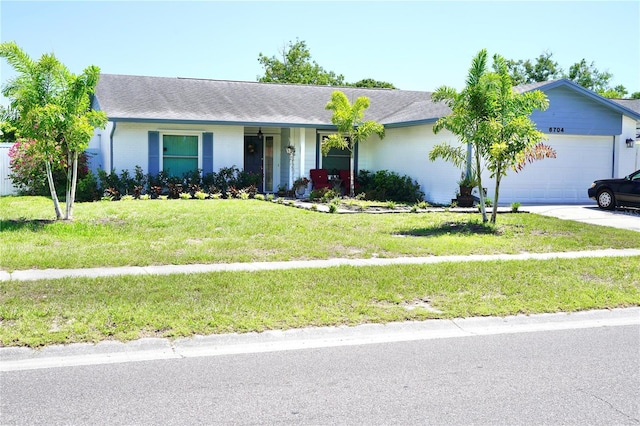 6704 Rosemary Dr, Tampa, FL 33625 - single story home featuring a garage, a front lawn, driveway, and a shingled roof
