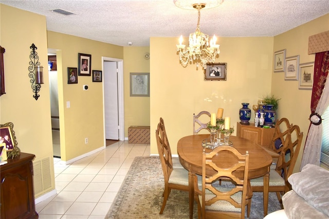6704 Rosemary Dr, Tampa, FL 33625 - dining area featuring a chandelier, light tile patterned floors, a textured ceiling, and baseboards