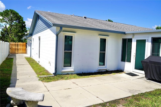 6704 Rosemary Dr, Tampa, FL 33625 - back of property featuring a shingled roof and a patio area
