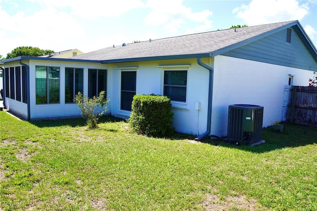 6704 Rosemary Dr, Tampa, FL 33625 - back of house featuring central AC unit, roof with shingles, a sunroom, and concrete block siding