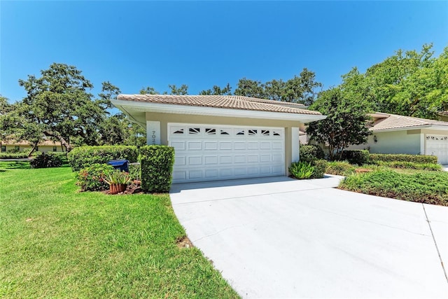 7023 Woodside Oaks Cir Unit 1, Sarasota, FL 34231 - view of front of property featuring a garage, a tile roof, a front yard, and driveway