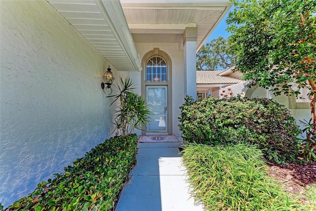 7023 Woodside Oaks Cir Unit 1, Sarasota, FL 34231 - view of exterior entry with stucco siding