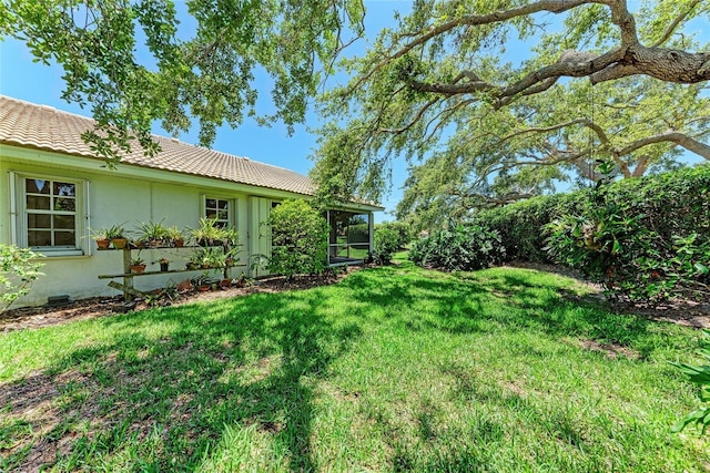 7023 Woodside Oaks Cir Unit 1, Sarasota, FL 34231 - view of grassy yard featuring a sunroom