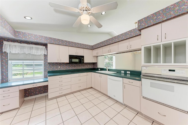 7023 Woodside Oaks Cir Unit 1, Sarasota, FL 34231 - kitchen with white appliances, a sink, vaulted ceiling, white cabinetry, and light tile patterned floors