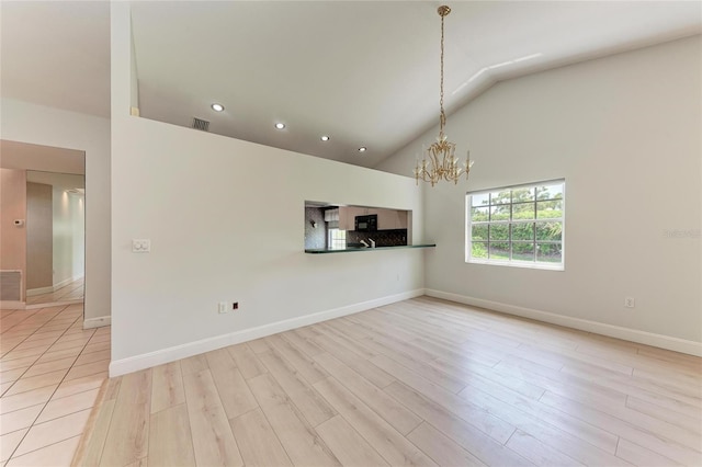 7023 Woodside Oaks Cir Unit 1, Sarasota, FL 34231 - unfurnished living room featuring a chandelier, recessed lighting, light wood finished floors, baseboards, and high vaulted ceiling