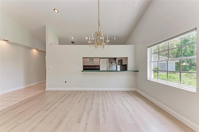 7023 Woodside Oaks Cir Unit 1, Sarasota, FL 34231 - unfurnished living room featuring a chandelier, high vaulted ceiling, wood finished floors, recessed lighting, and baseboards