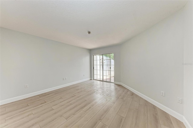7023 Woodside Oaks Cir Unit 1, Sarasota, FL 34231 - unfurnished room featuring light wood finished floors and baseboards