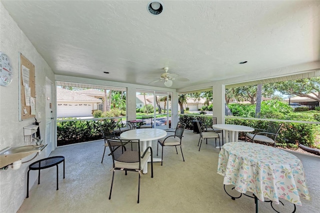 7023 Woodside Oaks Cir Unit 1, Sarasota, FL 34231 - sunroom / solarium with outdoor dining space, ceiling fan, and a textured ceiling