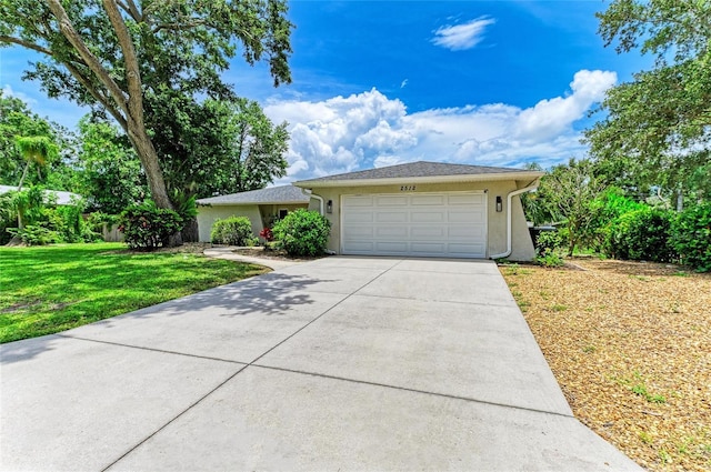 7023 Woodside Oaks Cir Unit 1, Sarasota, FL 34231 - ranch-style home with an attached garage, driveway, stucco siding, and a front lawn