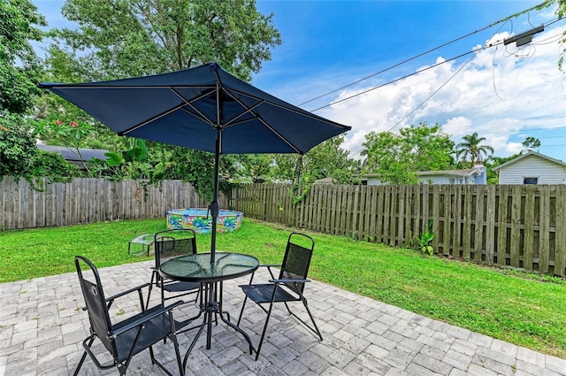 7023 Woodside Oaks Cir Unit 1, Sarasota, FL 34231 - fenced backyard with a patio area and outdoor dining area