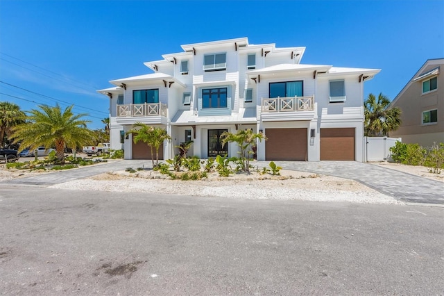 401 39th St, Holmes Beach, FL 34217 - beach home with a balcony, a garage, driveway, and stucco siding
