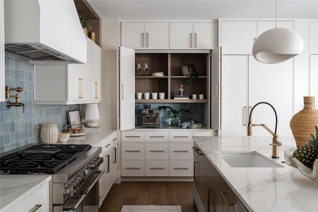 401 39th St, Holmes Beach, FL 34217 - kitchen with double oven range, wall chimney range hood, backsplash, and a sink