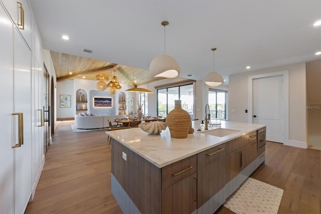 401 39th St, Holmes Beach, FL 34217 - kitchen featuring a sink, open floor plan, modern cabinets, light wood-style flooring, and recessed lighting
