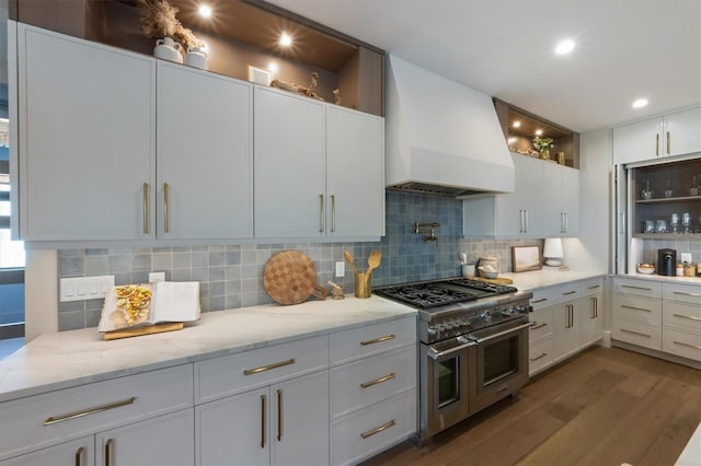 401 39th St, Holmes Beach, FL 34217 - kitchen featuring double oven range, custom range hood, dark wood-style floors, decorative backsplash, and light stone countertops