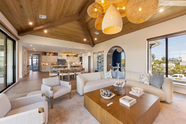 401 39th St, Holmes Beach, FL 34217 - living room with wood ceiling with exposed beams, arched walkways, light wood-type flooring, high vaulted ceiling, and recessed lighting