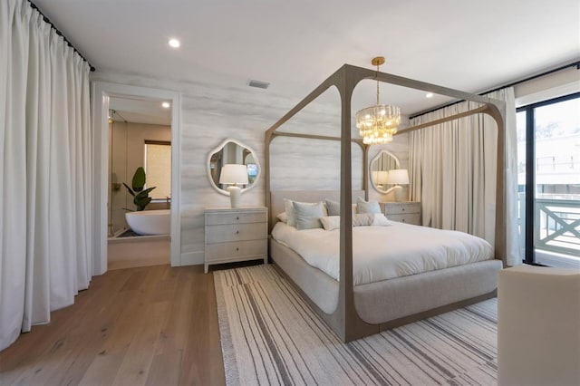 401 39th St, Holmes Beach, FL 34217 - bedroom featuring wood finished floors, a chandelier, recessed lighting, and access to exterior