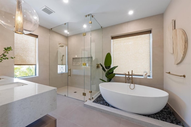 401 39th St, Holmes Beach, FL 34217 - bathroom featuring a stall shower, a soaking tub, vanity, tile patterned floors, and recessed lighting