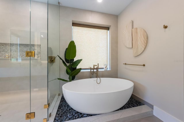 401 39th St, Holmes Beach, FL 34217 - bathroom with a soaking tub, a shower stall, and baseboards