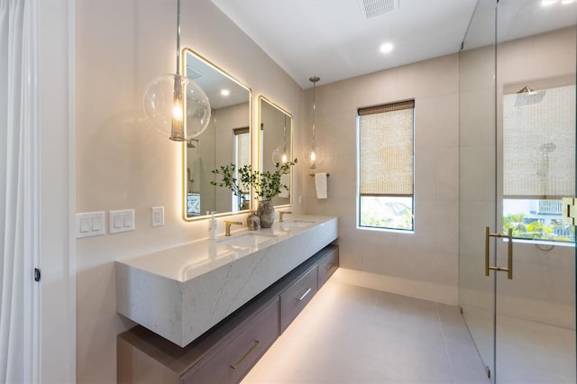 401 39th St, Holmes Beach, FL 34217 - bathroom featuring a shower stall, double vanity, tile patterned flooring, and recessed lighting