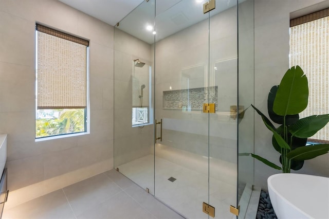 401 39th St, Holmes Beach, FL 34217 - full bathroom featuring a shower stall, a freestanding tub, and tile patterned floors