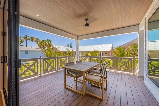 401 39th St, Holmes Beach, FL 34217 - wooden deck with outdoor dining area and a ceiling fan
