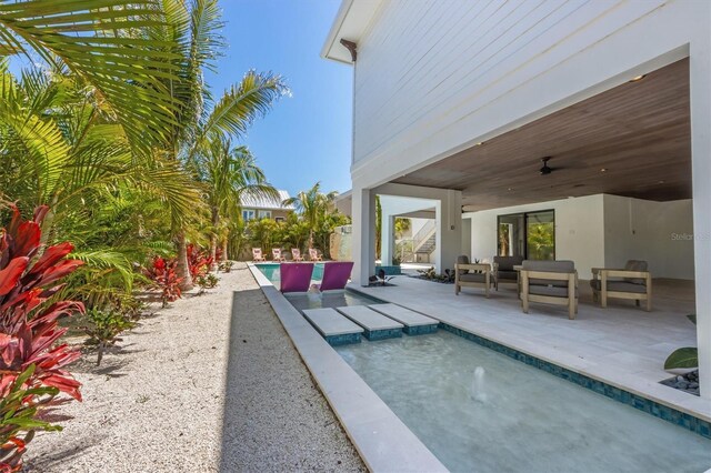 401 39th St, Holmes Beach, FL 34217 - swimming pool featuring a ceiling fan, a patio area, and an outdoor living space