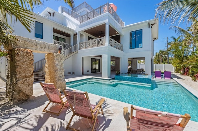 401 39th St, Holmes Beach, FL 34217 - rear view of property featuring a balcony, a ceiling fan, stairs, a patio area, and stucco siding