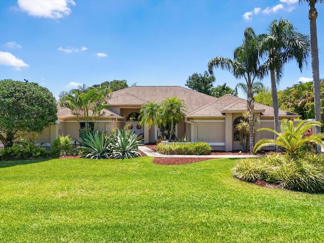 7321 Hemlock Ln, Sarasota, FL 34241 - view of front facade with stucco siding and a front lawn