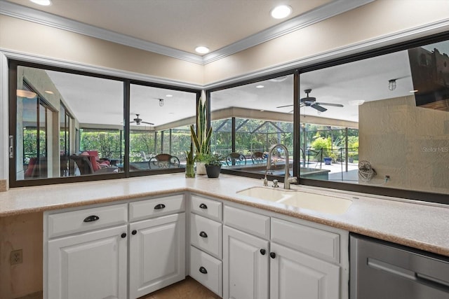 7321 Hemlock Ln, Sarasota, FL 34241 - kitchen with dishwasher, a sink, a ceiling fan, crown molding, and white cabinetry