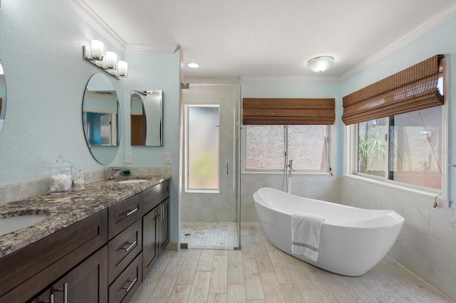 7321 Hemlock Ln, Sarasota, FL 34241 - full bathroom featuring a shower stall, a soaking tub, double vanity, ornamental molding, and wood finished floors
