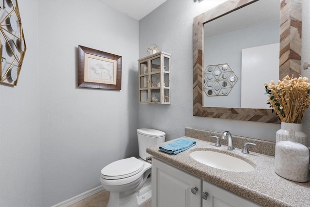 7321 Hemlock Ln, Sarasota, FL 34241 - bathroom featuring toilet, vanity, baseboards, and tile patterned floors