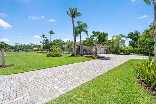 7321 Hemlock Ln, Sarasota, FL 34241 - view of green lawn with an attached garage and decorative driveway