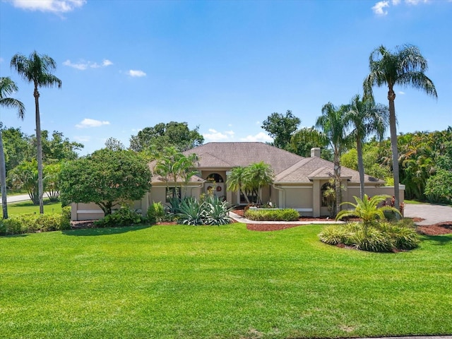 7321 Hemlock Ln, Sarasota, FL 34241 - mediterranean / spanish-style home featuring a front lawn and stucco siding