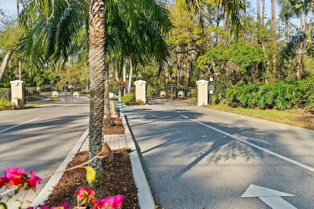 7321 Hemlock Ln, Sarasota, FL 34241 - view of asphalt street with a gate, curbs, and a gated entry